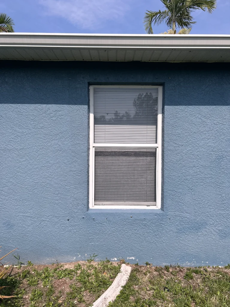 Window before accordion storm shutters setup | Sun Control Aluminum & Remodeling
