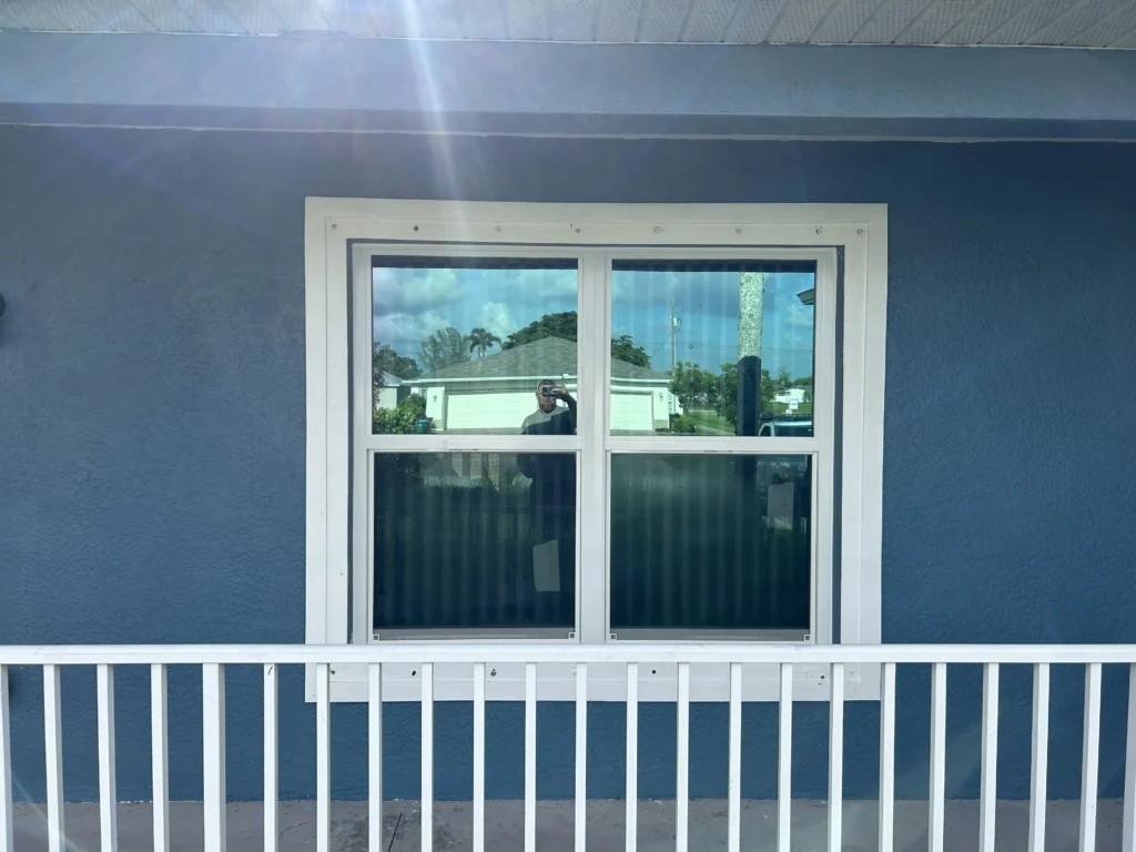 Modern window installation on a residential home featuring a clean, white vinyl frame and clear glass panes without grids enhancing the home's facade | Sun Control Aluminum & Remodeling